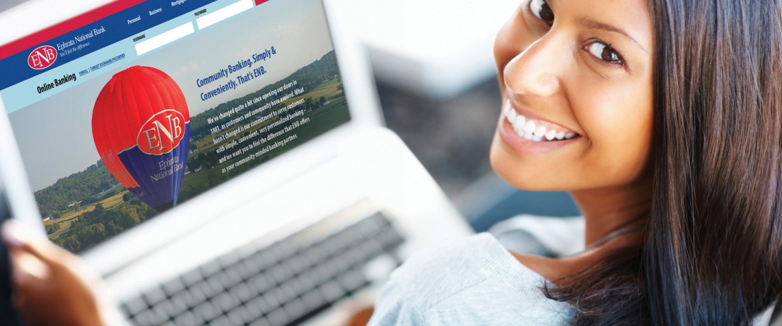 An online mobile banking customer from Ephrata National Bank looks up from her computer