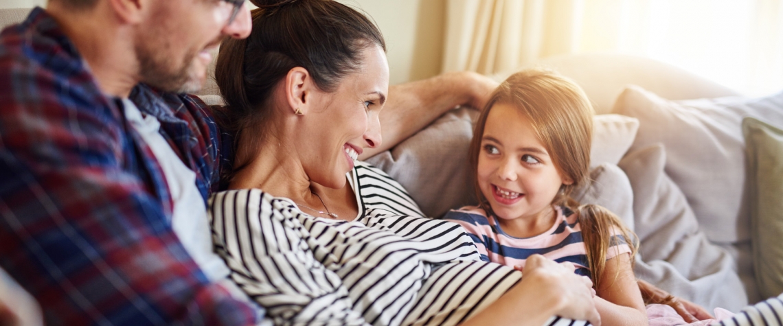 A new family sits on their couch and thinks about their future