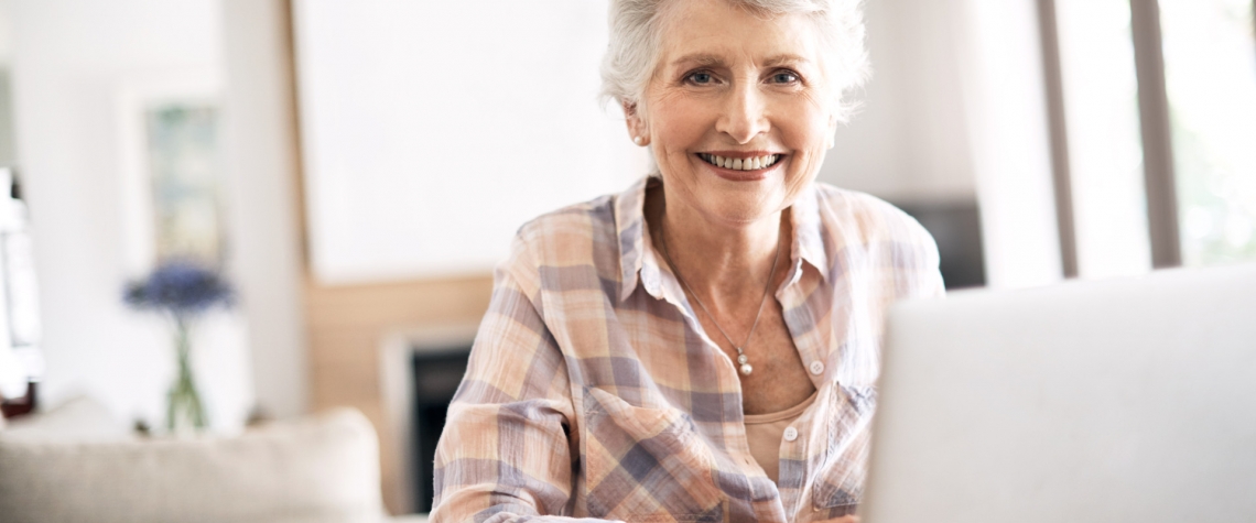 A retired woman checks her eStatements from her home computer