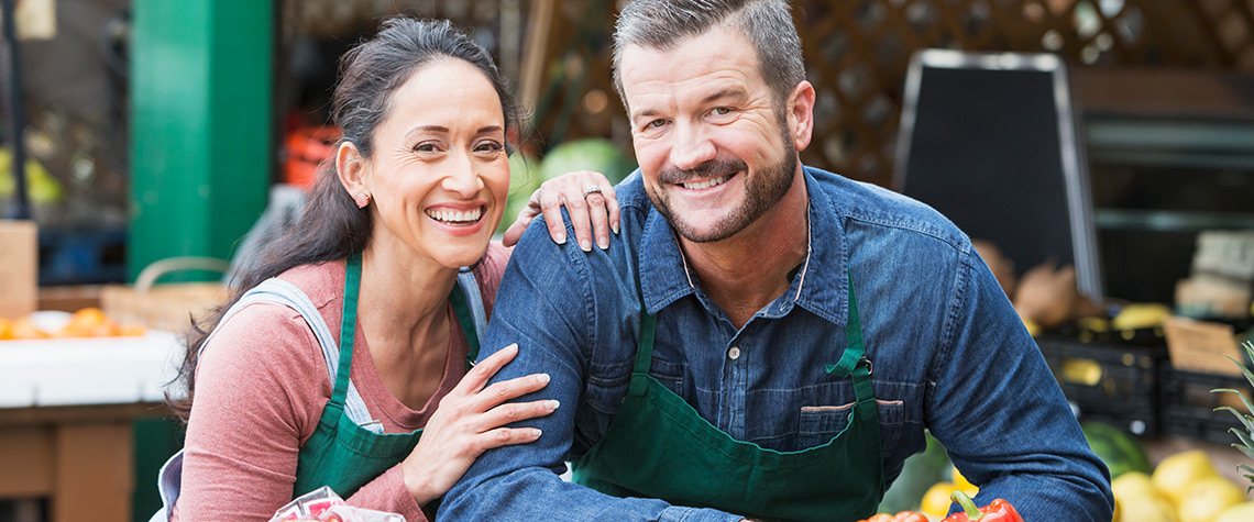 A male and female couple business owners in their workplace