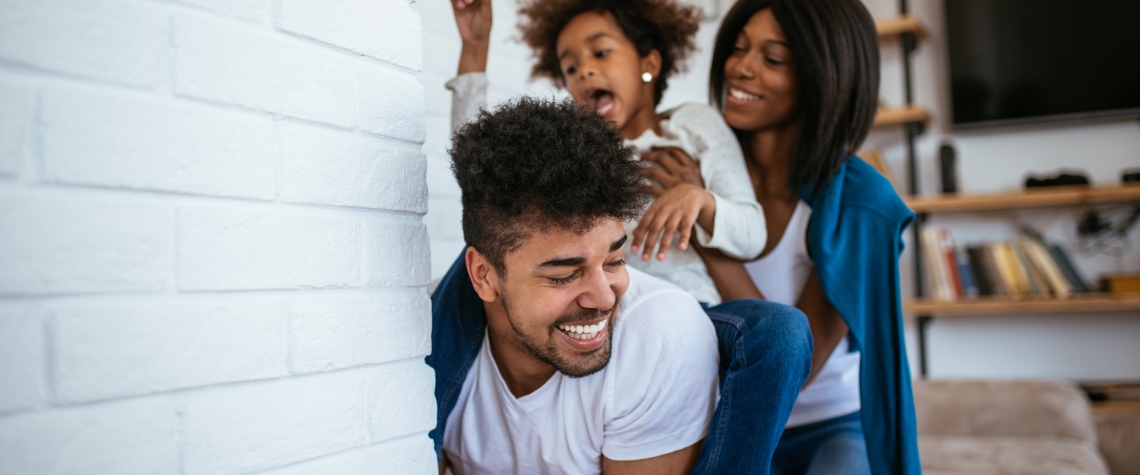 Happy african american family having fun at home.