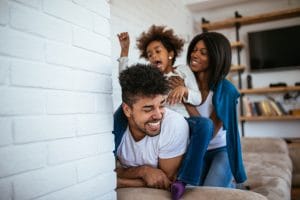 Happy african american family having fun at home.