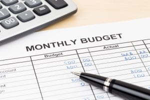 Home budget planning sheet with pen and calculator