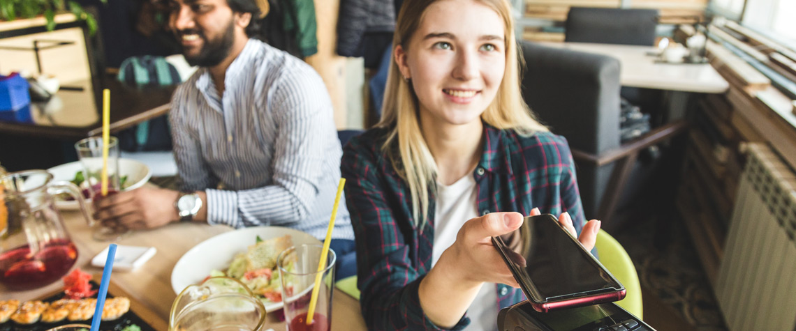 Woman paying electronically with her phone