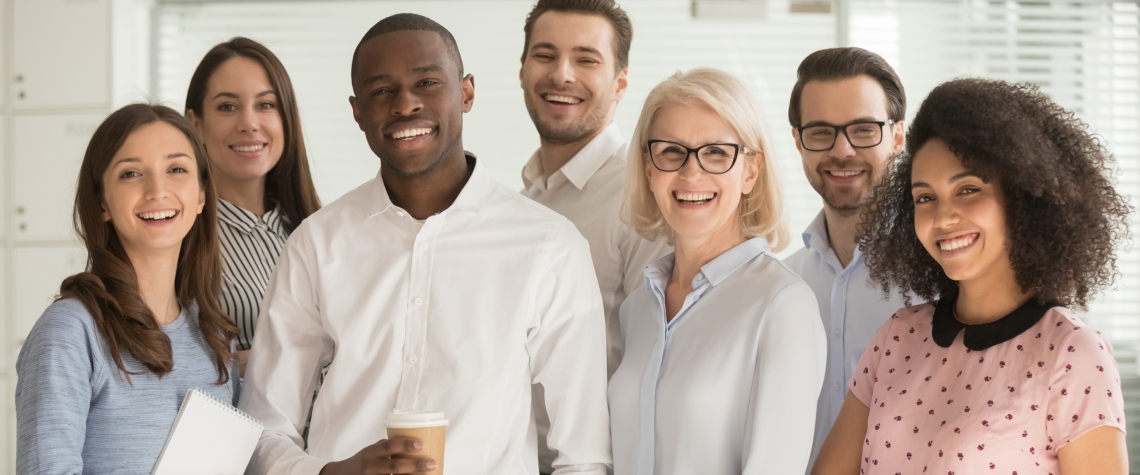 Motivated international multi-ethnic company members aged and young corporate team photographing posing for camera, successful staff portrait concept of growth in career leadership and racial equality