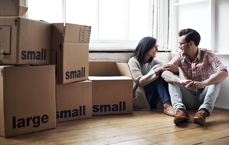 Couple relaxing after moving into new cozy loft apartment