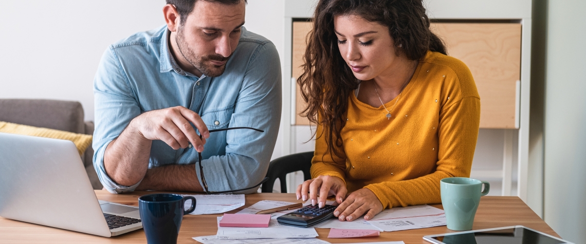 Young couple calculating their domestic bills at home stock photo