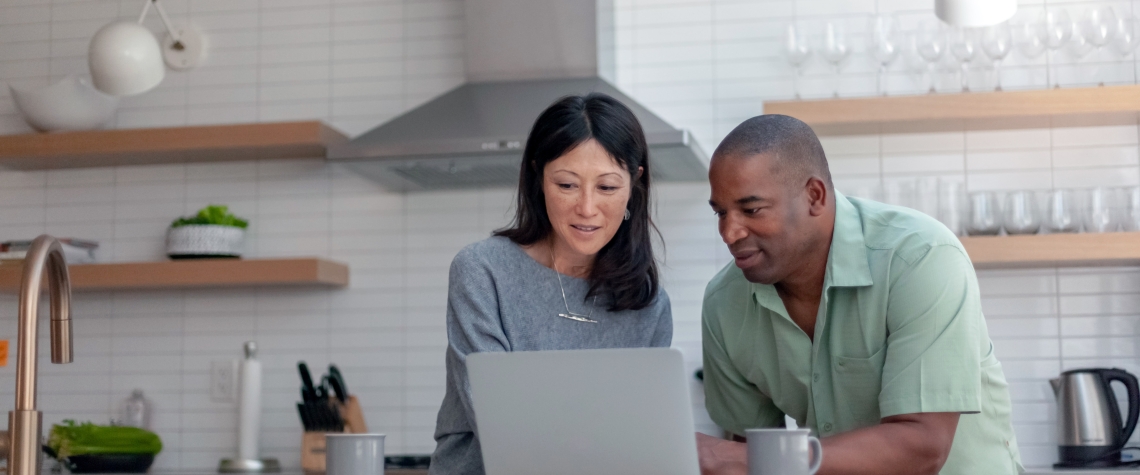 Husband and Wife looking at a laptop