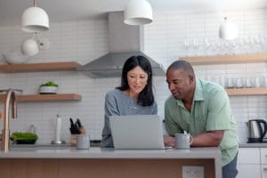 Husband and Wife looking at a laptop