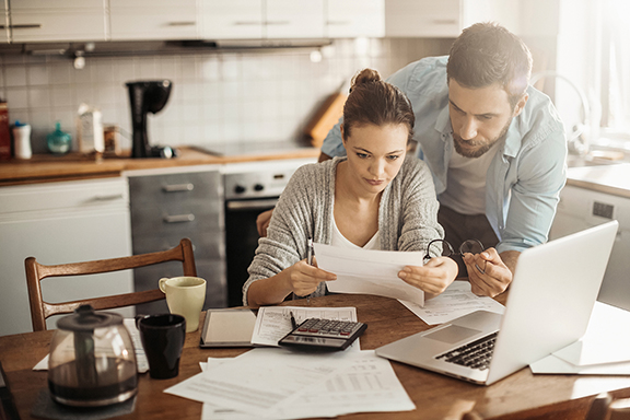 Couple at the kitchen table looking at paperwork