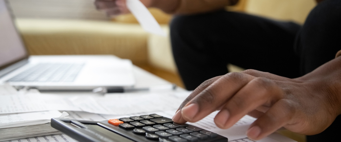 Someone using a calculator to track finances