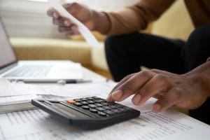 Someone using a calculator to track finances