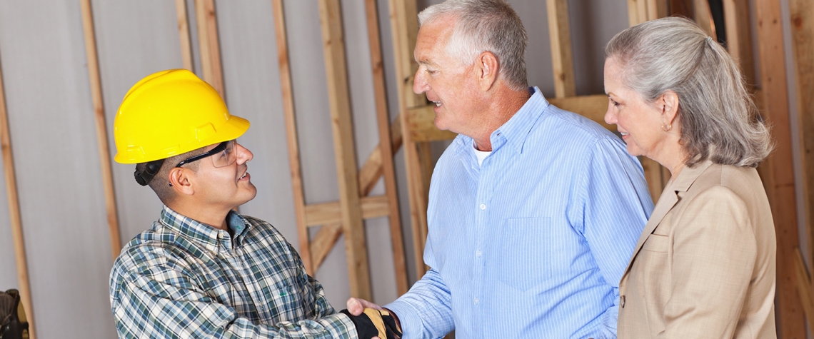 House owners greeting building contractor.