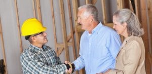 House owners greeting building contractor.
