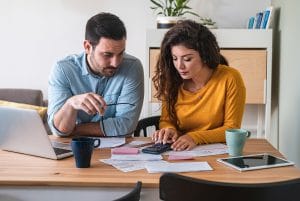 Couple at a table looking over documents