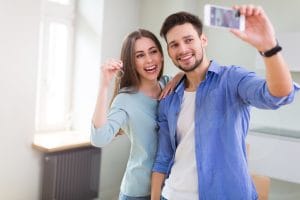 First Time homebuyers with keys to new home