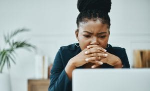 Lady looking at her laptop worried